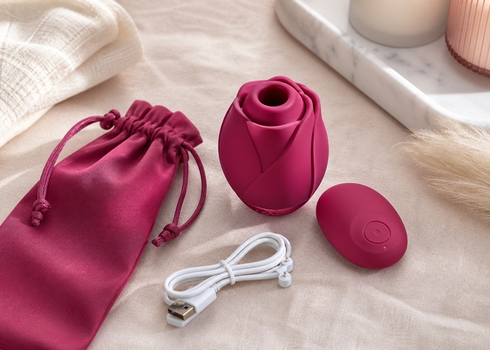 Clean rose-shaped adult wellness products, cleanser bottle, and pouch arranged on a tidy countertop