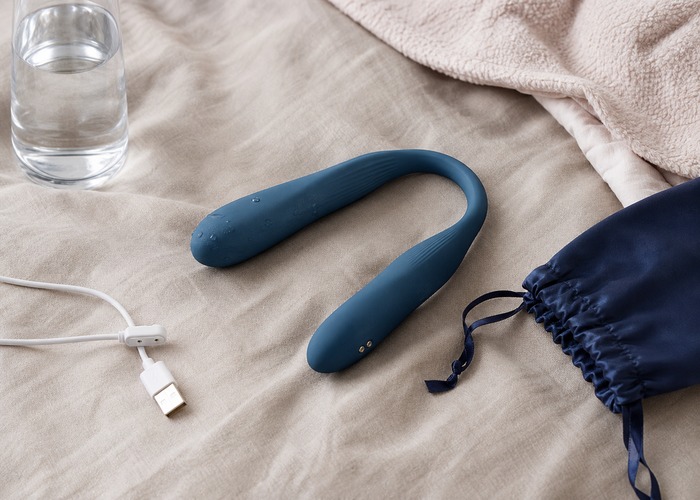 Rabbit Vibrators guide product scene with dual-arm wellness device, water-based lube, charging cable