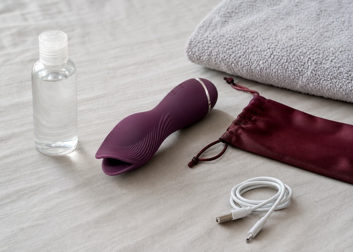 Tongue Vibrators guide product scene with tongue-style head, water-based lube, charging cable